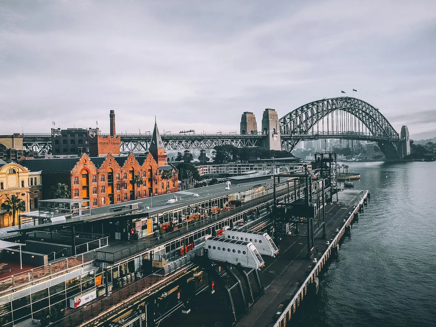 Sydney Harbour Bridge rising over the historic sandstone buildings of The Rocks