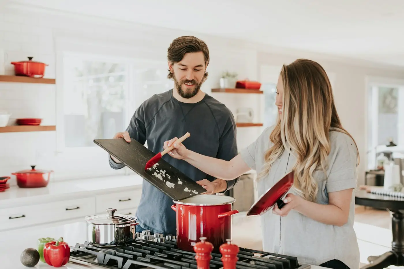 Man and woman cooking a meal together at a stove