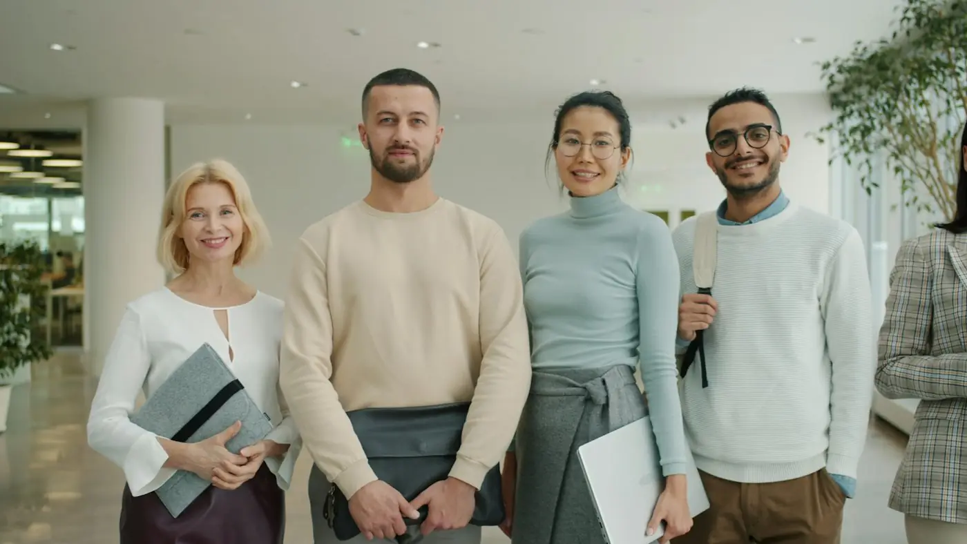 Four Enrichment Care team members standing together in an office